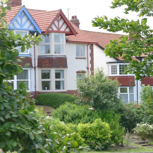 a white house with a red roof at White Acre in Scarborough