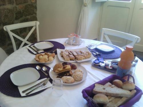 a white table with plates of food on it at Viterbo Antica - centro storico in Viterbo