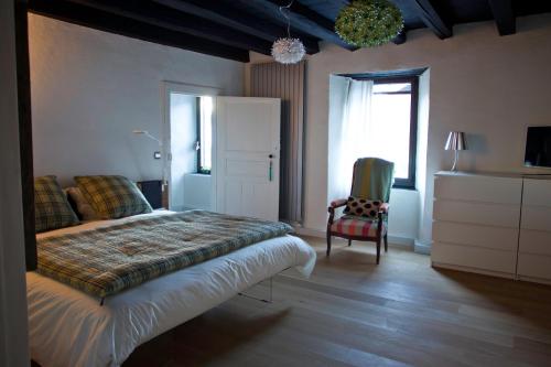 Cazeaux-de-LarboustにあるMaison Eth Bordac & Bordac Petitのベッドルーム1室(ベッド1台、椅子、窓付)