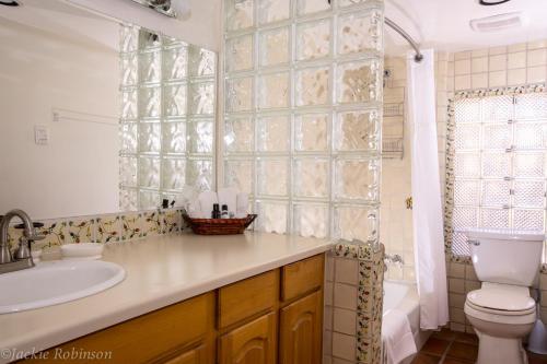 a bathroom with a sink and a toilet and a shower at Casa La Huerta in Albuquerque