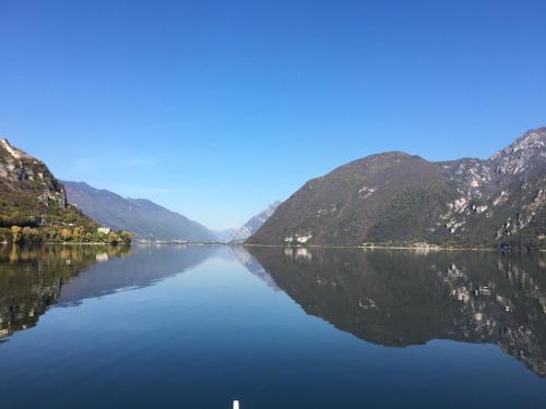 a view of a lake between two mountains at Albergo al lago in Anfo