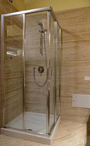 a shower with a glass enclosure in a bathroom at Wendy luxury apartment in Venice