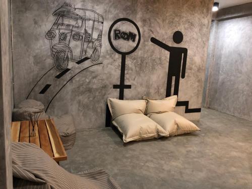 a room with a bed and a person holding a sign at Blackjack Bar and Hostel in Chaweng