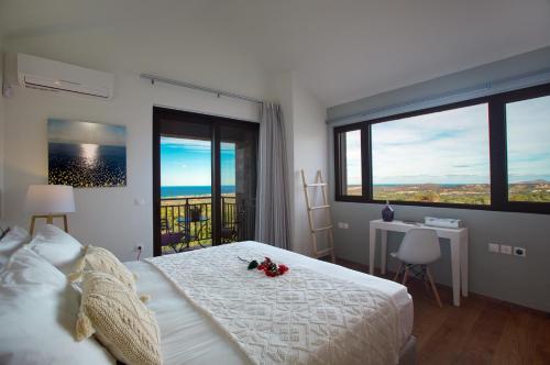 a bedroom with a bed with flowers on it at Arion Krini villa in Amnátos