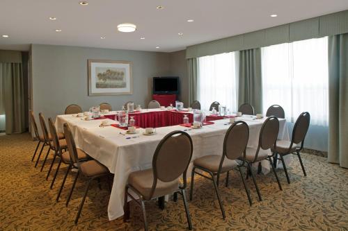 a conference room with a long table and chairs at Travelodge by Wyndham Oshawa Whitby in Oshawa