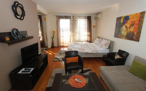 a living room with a bed and a couch at Twin Belville Apartments in Belgrade