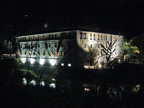a large building lit up at night with lights at Villaggio Albergo San Lorenzo e Santa Caterina in Pescia