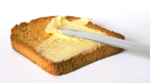 a piece of bread with a knife on it at Hotel Preetam Aurangabad in Aurangabad