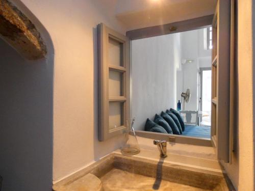 a bathroom with a tub with a large mirror at Pantelia Pyrgos in Pyrgos