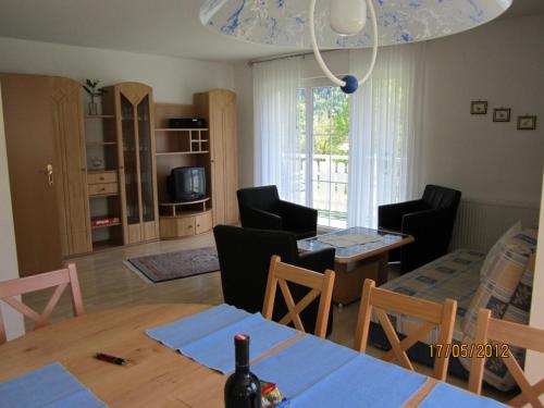 a kitchen and living room with a table and chairs at Landhaus Bürse in Flattach