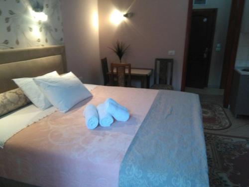 a bedroom with a bed with blue towels on it at Apartments Bogdanovic in Kotor