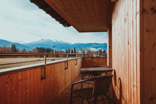 a table and chairs sitting on a porch with a view at Ferienwohnung Thannen in Lingenau
