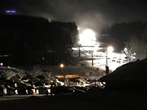 a ski slope lit up at night with lights at Apartmány Pinie Lipno in Lipno nad Vltavou