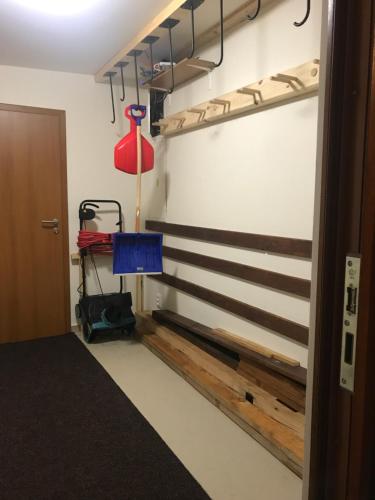 a room with wooden stairs and a red lamp at Apartmány Pinie Lipno in Lipno nad Vltavou