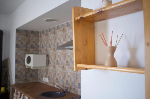 a kitchen with a sink and a counter with sticks at Villas de la Ermita in Vejer de la Frontera