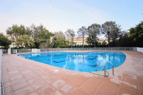 a large swimming pool with blue water at Saint Tropez Sea View Penthouse in Saint-Tropez