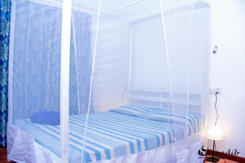 a bed with a canopy in a room at Serendib House in Unawatuna