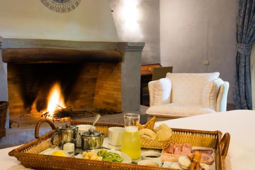 a tray of food on a table in front of a fireplace at Hacienda Historica Marchigue in Marchihue