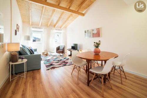 a living room with a table and chairs and a couch at Lis Apartments in Lisbon