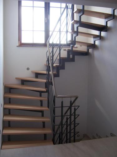 a spiral staircase in a house with a window at Domwigierski pl -Jeziorki -GR- Comfort-Ferienhaus-Polen - własna linia brzegowa i sauna in Wysoki Most