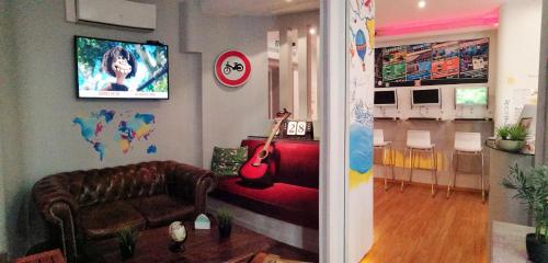 a living room with a couch and a guitar at Meyerbeer Beach in Nice