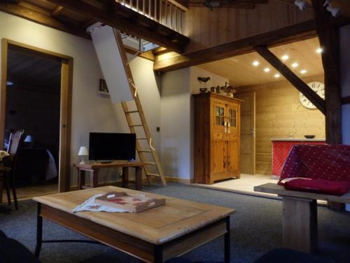 a living room with a ladder and a table at Gite l'Ancolie in Marignier