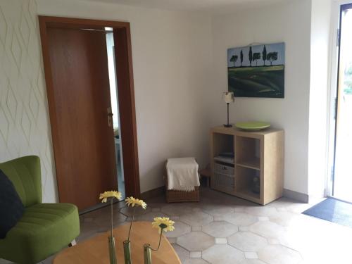 a living room with a tv and a couch and a table at Historical Apartment in Gummersbach