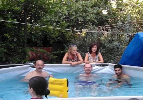 a group of people in a swimming pool at Giorgi's Homestay in Kutaisi