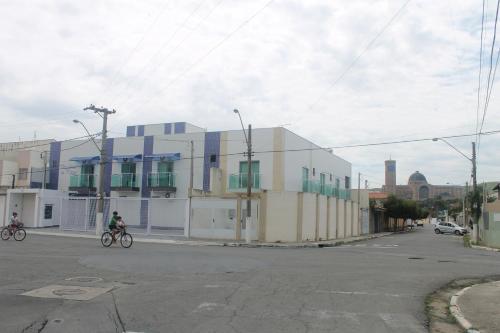 a person riding a bike in front of a building at Pousada Orquideas de Maria in Aparecida