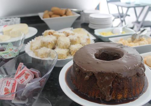 a chocolate cake on a plate on a table at Pousada Orquideas de Maria in Aparecida