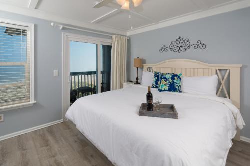 a bedroom with a white bed and a window at The Saint Augustine Beach House in Saint Augustine