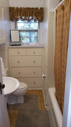 a bathroom with a sink and a toilet and a window at ❤️ Lovely Smart Craftsman King HDTV WIFI AC Yard in Klamath Falls