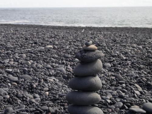 a stack of rocks sitting on a rocky beach at Camp Boutique in Gaulverjabær