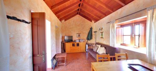 a living room with a couch and a table at Casa Rural Abuelo Pancho in Las Casas