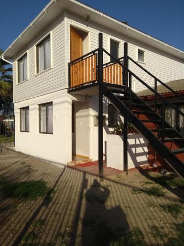 a house with a staircase in front of it at Departamento Familiar in Coquimbo
