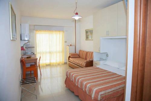 a hotel room with a bed and a couch at Apparthotel Residence Riviera dei Cedri in Santa Maria del Cedro