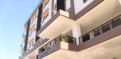 a building with balconies on the side of it at Sebastien Hotel in Mactan