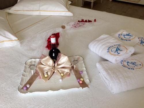 a white table with a bottle of wine and towels at Villa Zampeta in Adamas