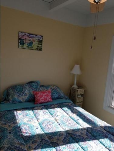 a bedroom with a bed with a quilt on it at donovan"s Reef in Oak Island