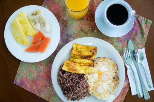 a table with two plates of food and a cup of coffee at La Casa de la Montaña in Monteverde Costa Rica