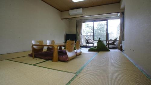 a room with a table and chairs and a large window at Hakone Forest of Verde in Hakone
