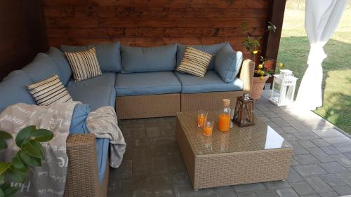 a living room with a blue couch and a table at Studio apartment Cami - Cottage with a soul in Gračišće