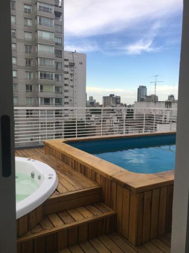 a balcony with a bath tub and a swimming pool at Departamento en Palermo Soho in Buenos Aires