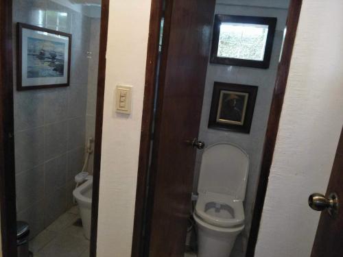 a bathroom with a toilet and a window at Stay Amare Villa Maria 1 in Bacolod
