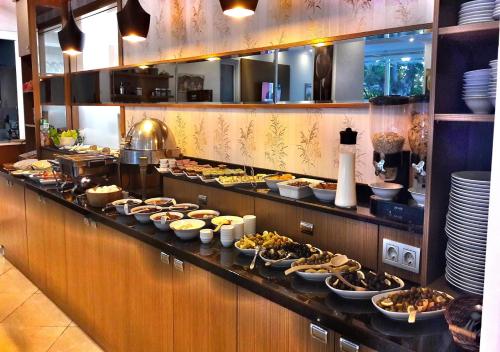 a buffet line with plates of food in a restaurant at Yeniceri City Hotel in Fethiye