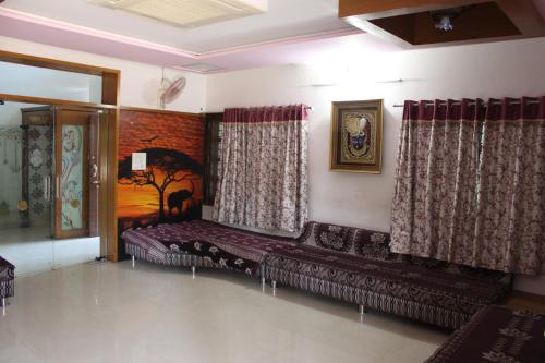 a living room with a couch and curtains at Classic Dineout in Gandhinagar