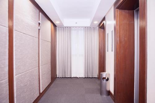 a hallway with a door and a trash can at The Charter House in Manila