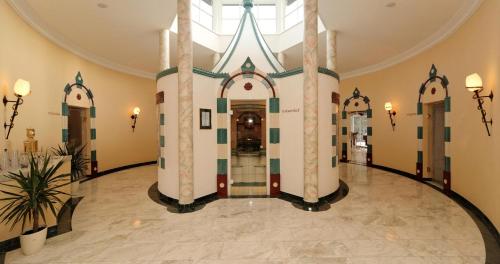 an empty lobby with a building with a doorway at Wellnesshotel Parkschlössl zu Thyrnau Ihr adults only SPA Resort in Thyrnau