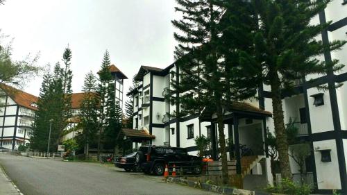 a black truck parked in front of a building at 3 Rooms Apt@Greenhill Resort in Cameron Highlands
