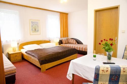 a hotel room with a bed and a couch at Pension Parzer Pressbaum bei Wien in Pressbaum